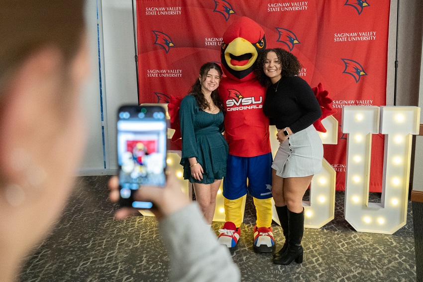 2 graduates and coop taking a photo at Senior Toast